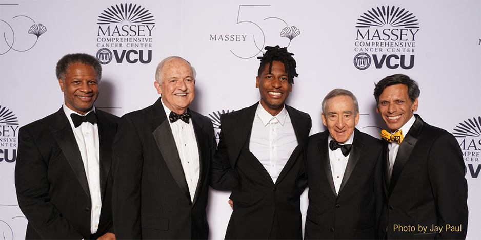 Photo of Massey directors Robert A. Winn, M.D., Gordon D. Ginder, M.D., I. David Goldman, M.D., and Michael Rao, Ph.D., VCU president, pictured with Jon Batiste (Center)